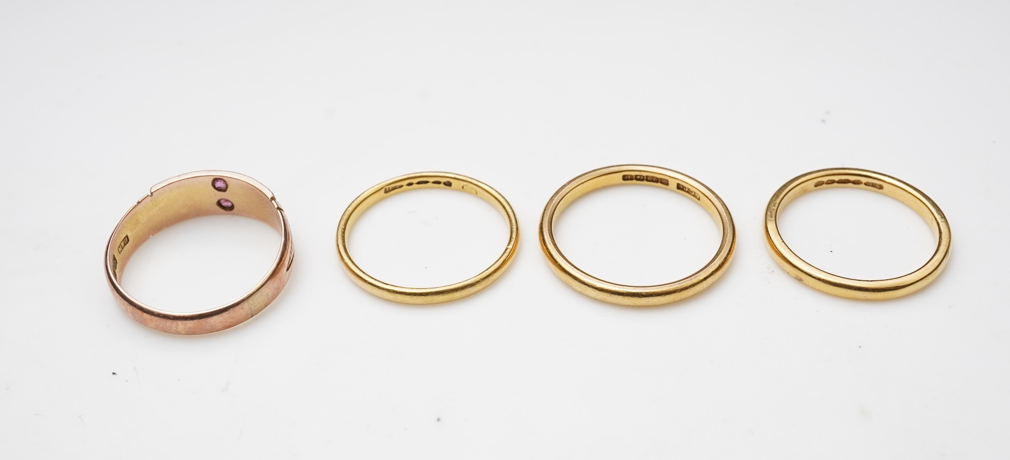 A collection of four gold rings